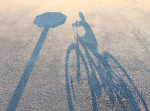 Shadow of bike and stop sign.